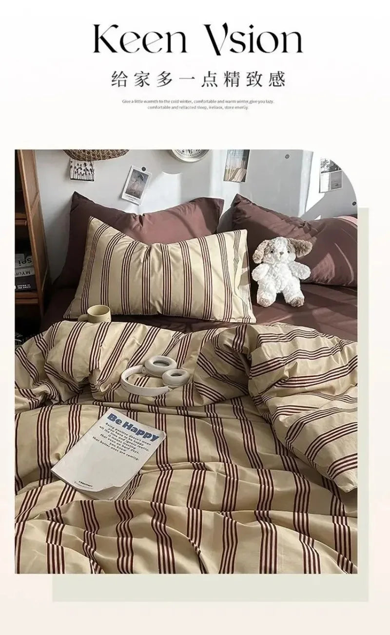Striped bedding set with pillows and a teddy bear on a bed, featuring the brand 'Keen Vision'.