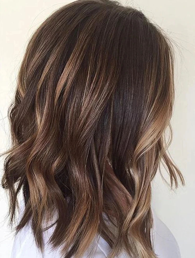Close-up of wavy brown hair with highlights on a white background