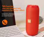 Red TWS speaker with text on a laptop and newspaper background