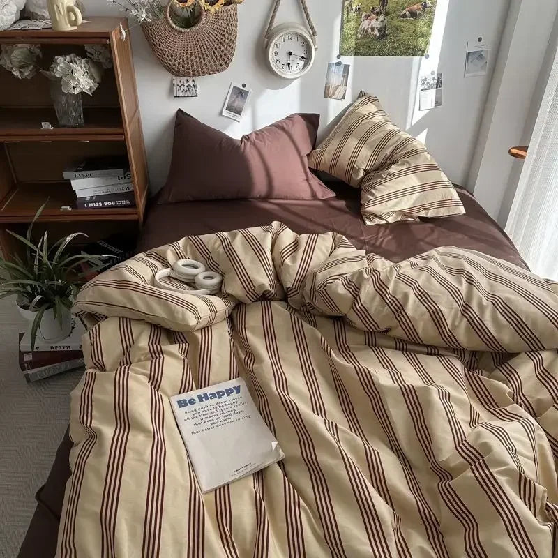 Bed with striped bedding and pillows in a cozy room setting.