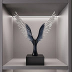 Decorative sculpture of wings on a pedestal in a modern interior setting