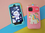 Two phone cases, one blue with a cartoon design and one pink with a unicorn design, on a colorful background.
