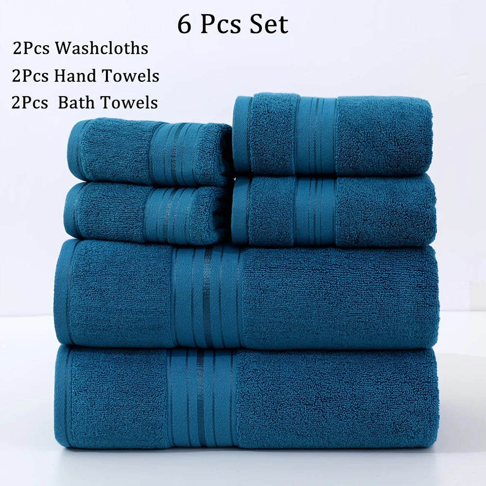 Set of blue towels including washcloths, hand towels, and bath towels on a white background.