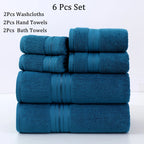 Set of blue towels including washcloths, hand towels, and bath towels on a white background.
