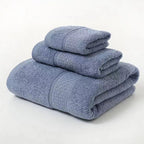 Set of three folded blue towels on a white background