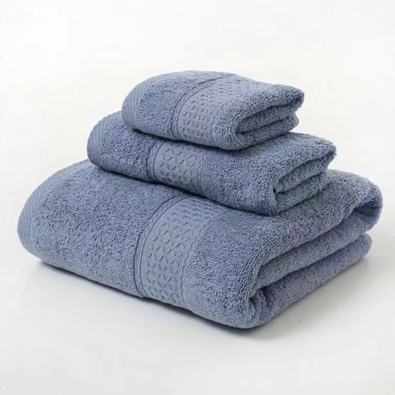 Set of three folded blue towels on a white background