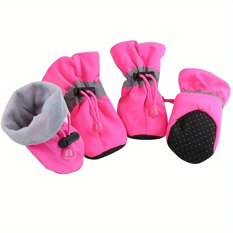 Set of pink pet boots with gray interior and black soles on a white background