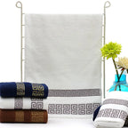 Set of folded towels with a decorative pattern on a white background