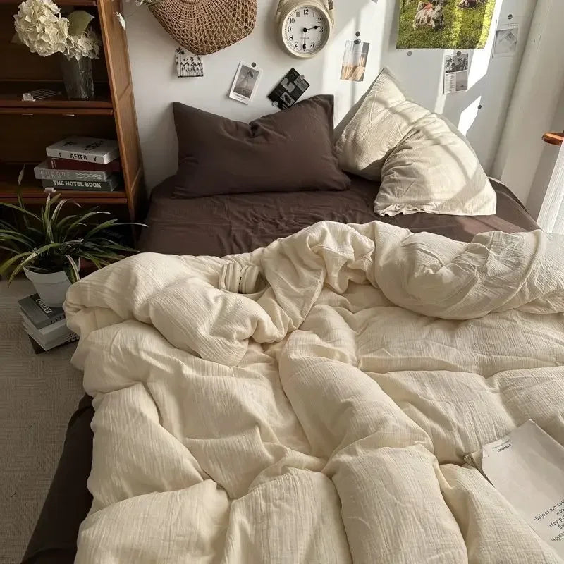 Neatly made bed with white comforter and pillows in a cozy bedroom setting.