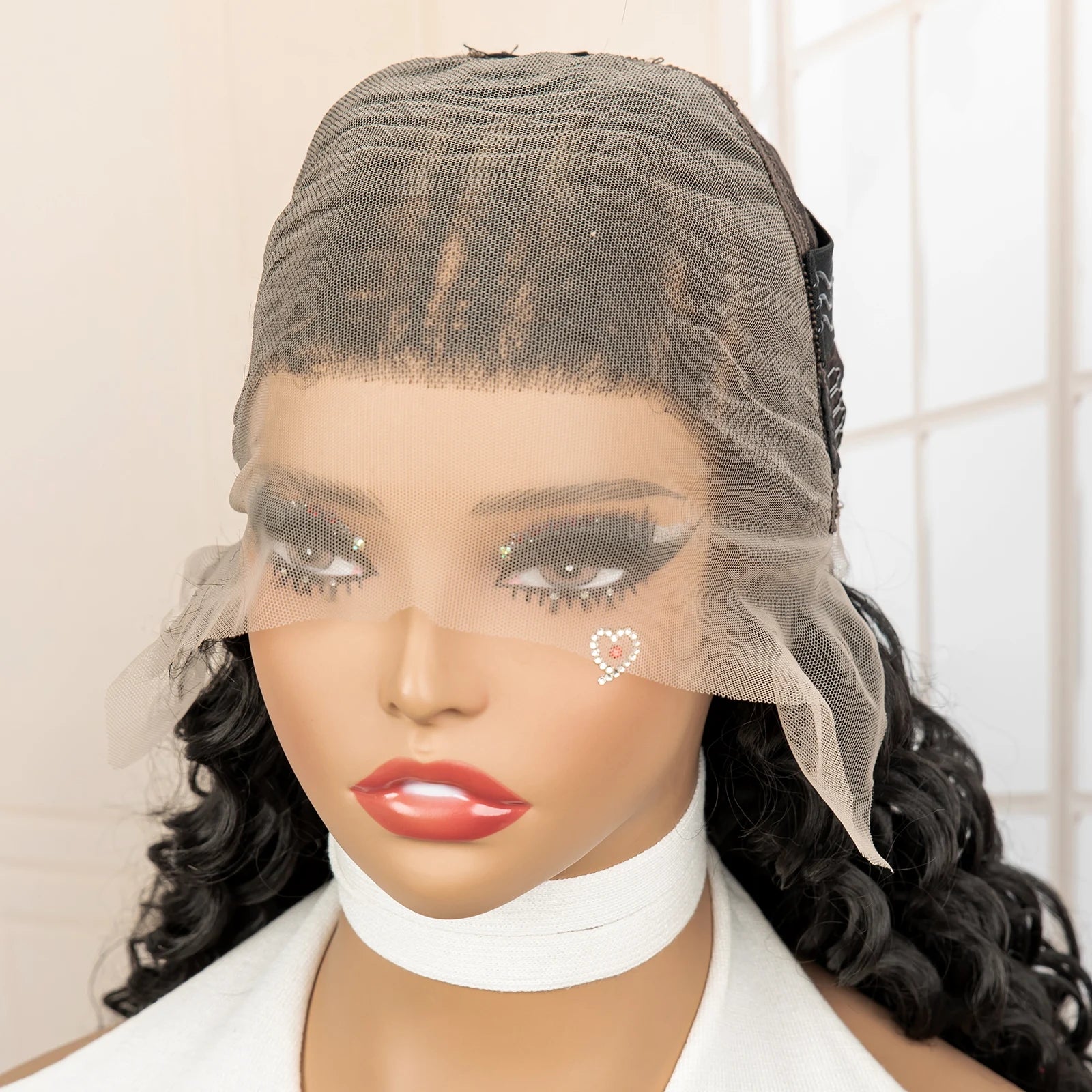 Mannequin head with a black lace front wig and white collar against a neutral background