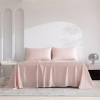 Pink satin bedspread and pillows on a bed in a minimalistic room.