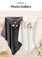 Gray and white hoodies with bear face designs hanging on a rack.