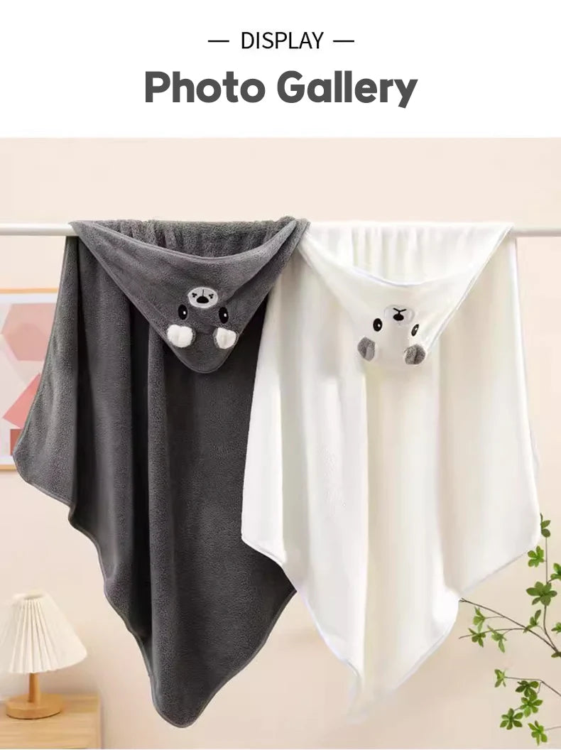 Gray and white hoodies with bear face designs hanging on a rack.