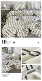 Striped bedding set with a comforter and pillows on a bed, featuring the brand 'Healthy'.