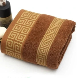 Brown towel with decorative pattern on a white background