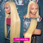 Blonde wig displayed on a mannequin head with a textured blue background