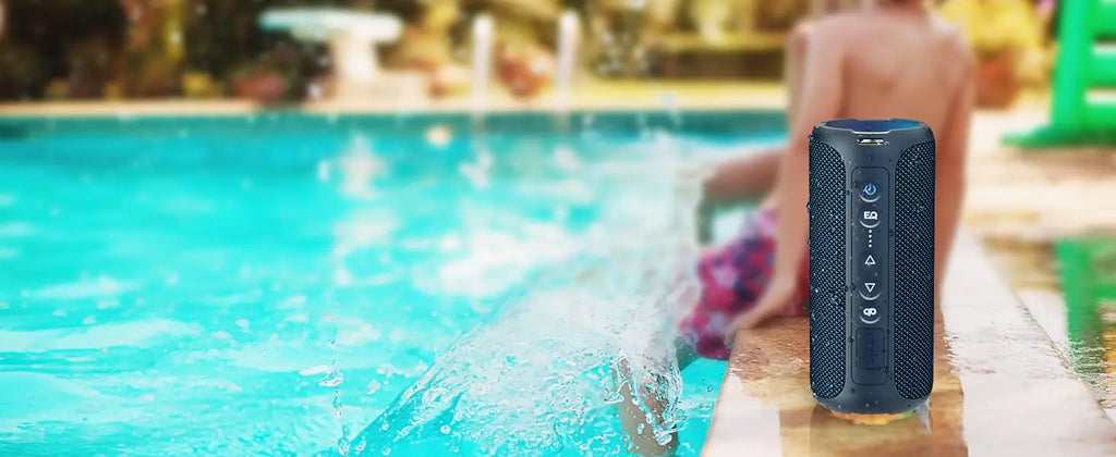 Blue portable speaker by a pool with a blurred background