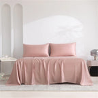 Pink satin sheet set on a bed with a minimalistic background