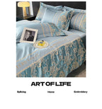 Luxurious blue embroidered bedding set with 'Art of Life' branding.
