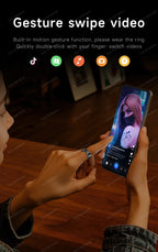 Person using a smartphone with gesture swipe video feature on a wooden table.