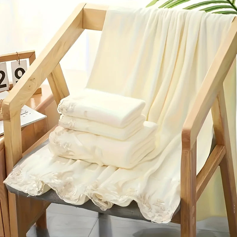 Stack of white towels on a wooden chair with a light background