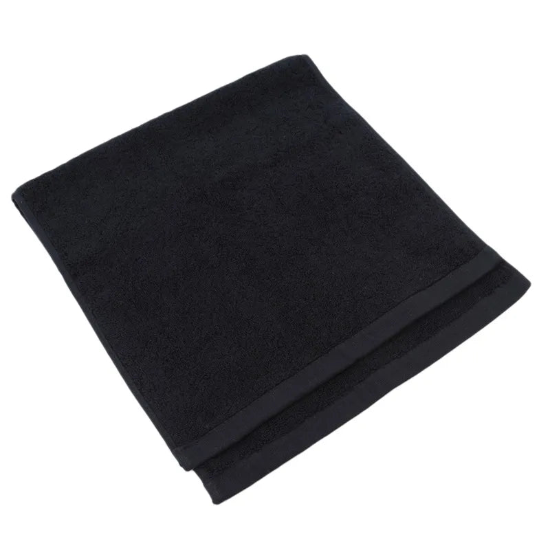 Folded black blanket on a white background