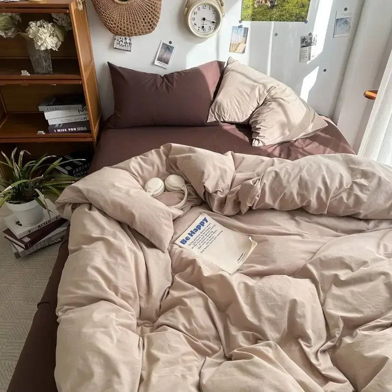 Neatly made bed with brown bedding in a room with a bookshelf and decorative items.