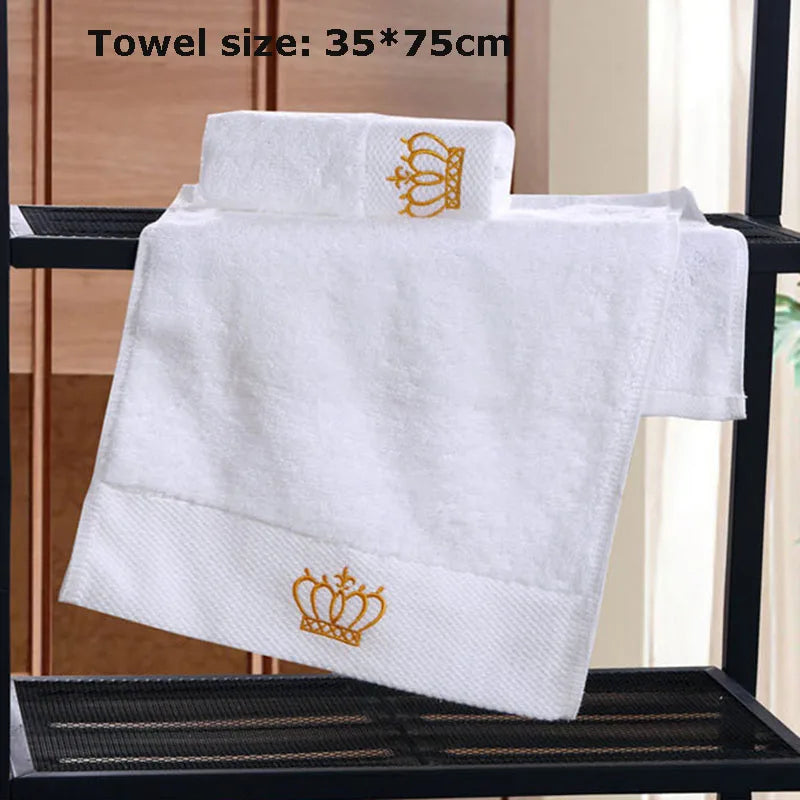 White towel with gold crown design on a black metal rack, size 35*75cm.