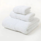 Set of white towels on a light gray background