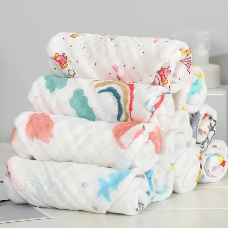 Stack of colorful baby blankets with cartoon designs on a light gray background
