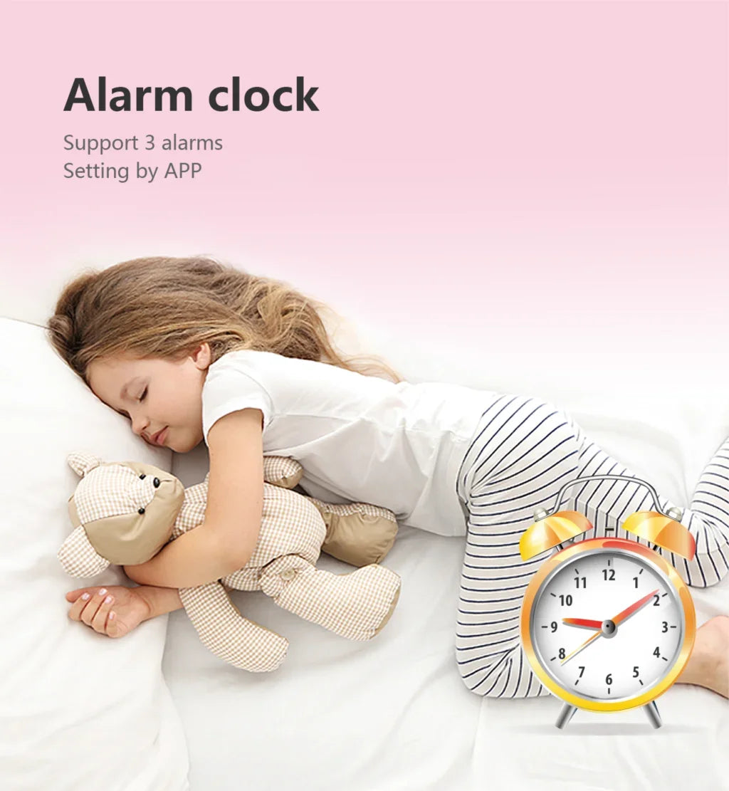 Child sleeping with a teddy bear next to an alarm clock on a pink background