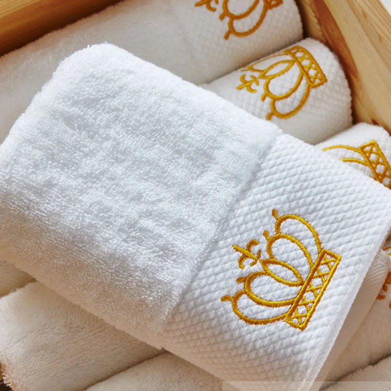 White towels with gold embroidery in a wooden box
