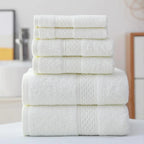 Stack of white towels on a surface with a blurred bathroom background