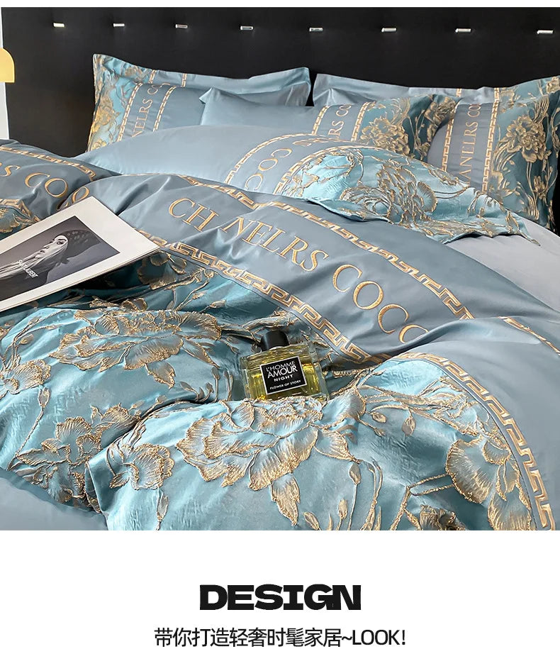 Luxury bedding set with floral patterns and 'Chanel' branding, featuring a bottle of perfume.