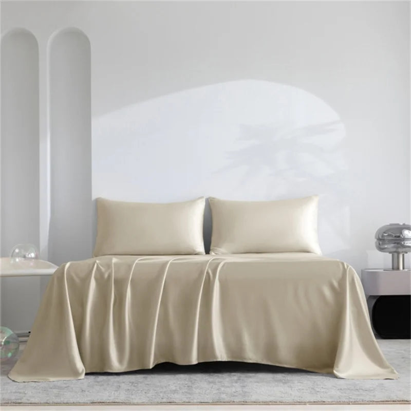 Beige satin sheet set on a bed with a minimalistic background