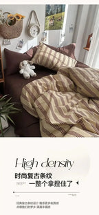 Striped bedding set on a bed with a teddy bear and decorative items in the room.