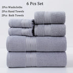 Set of gray towels including washcloths, hand towels, and bath towels on a white background.