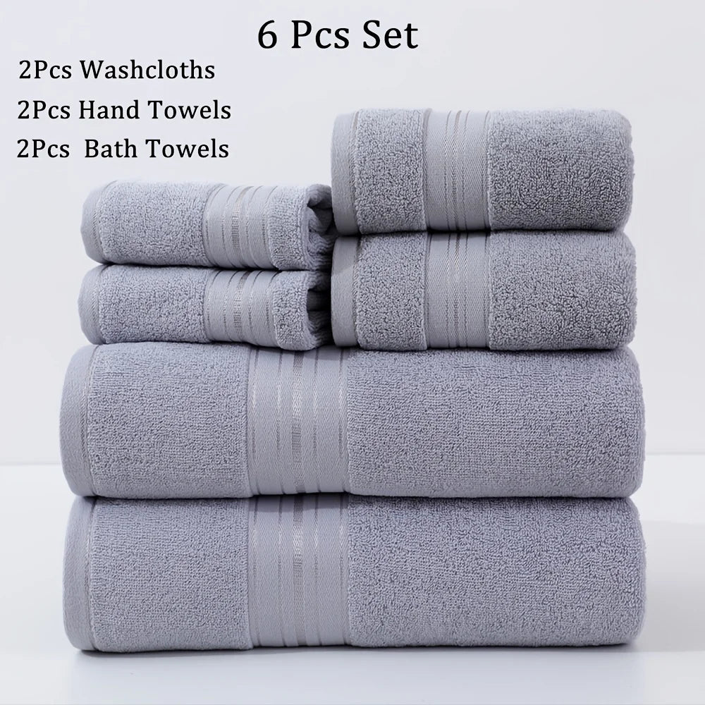 Set of gray towels including washcloths, hand towels, and bath towels on a white background.
