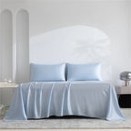 Light blue satin sheet set on a bed with a neutral background