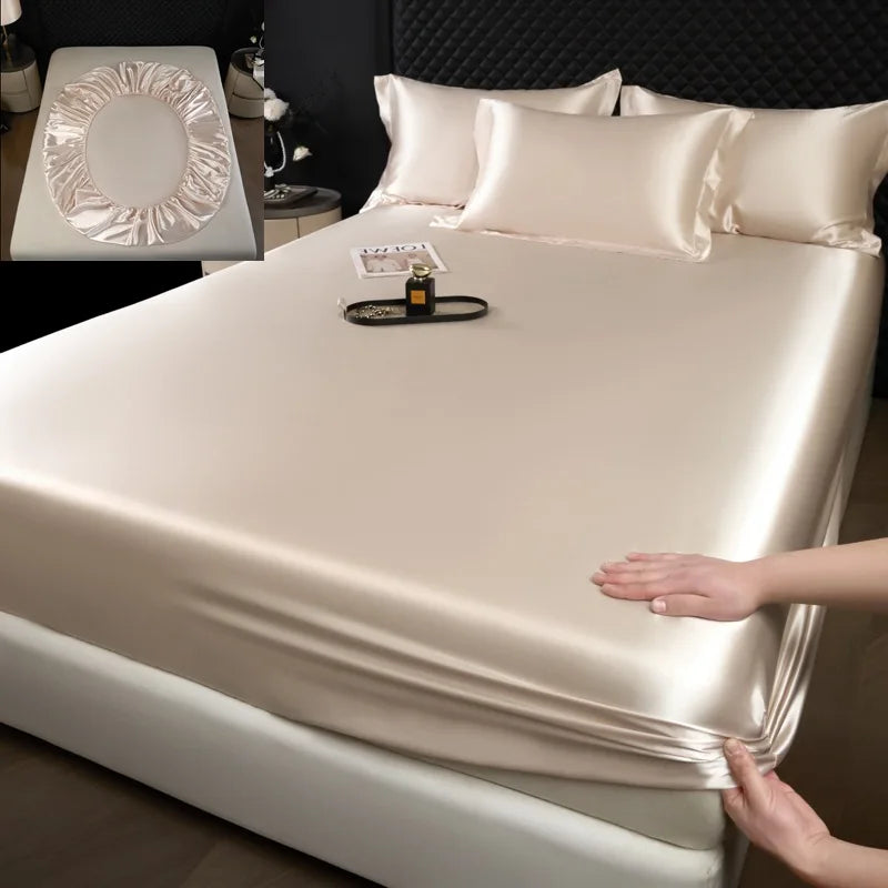 Mattress protector being fitted onto a bed with a close-up inset of a mattress cover.