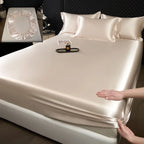 Mattress protector being fitted onto a bed with a close-up inset of a mattress cover.