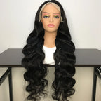 Black wavy wig on a mannequin head with a white background