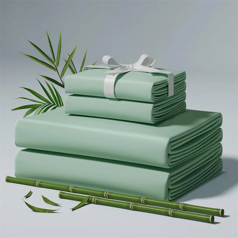 Stack of green fabric sheets with a white ribbon, surrounded by bamboo stalks on a light gray background.