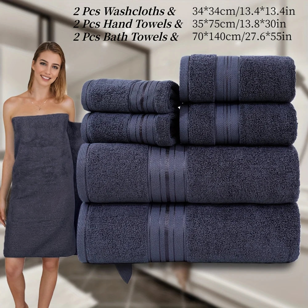 Set of navy blue towels including washcloths, hand towels, and bath towels with a woman holding a towel.