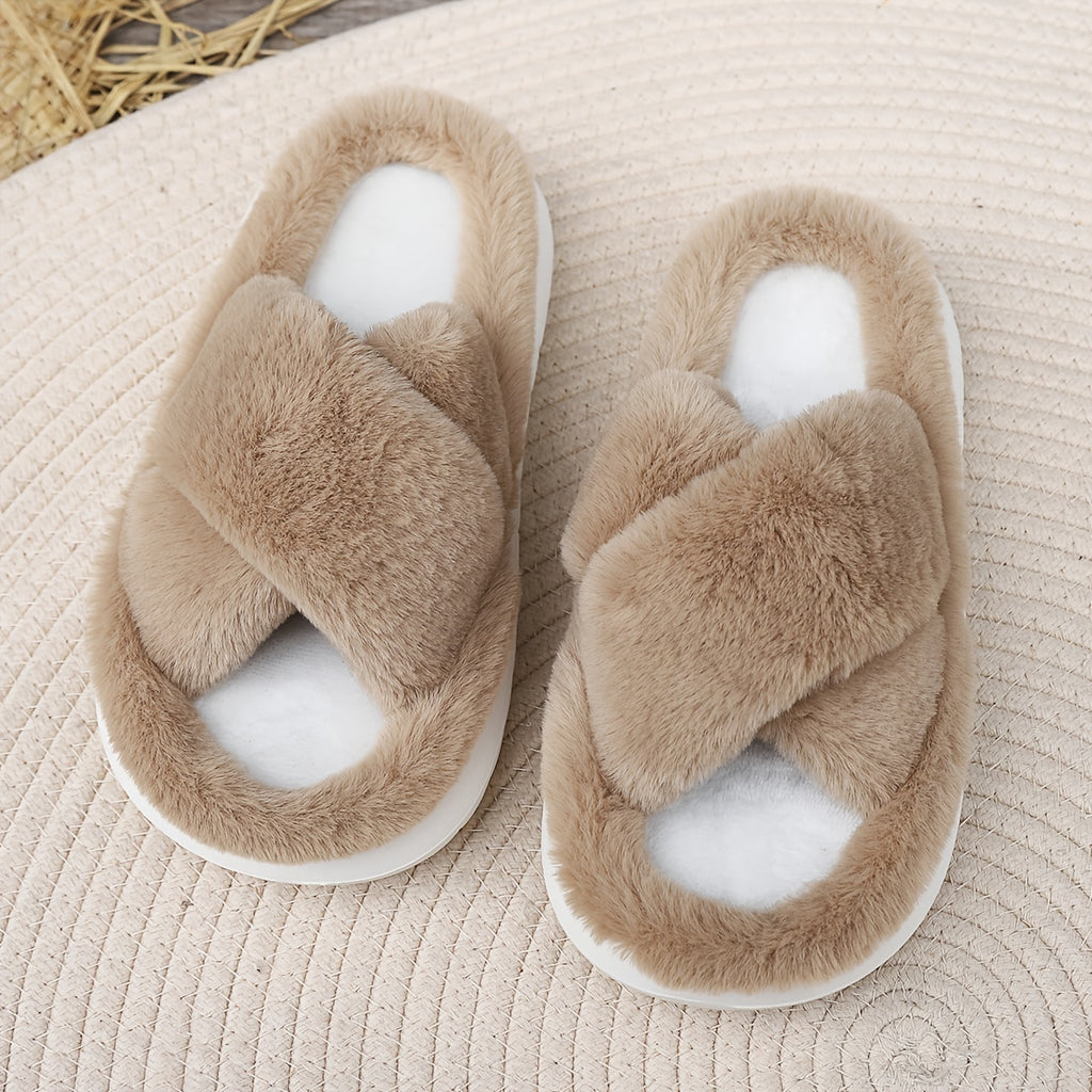 Pair of fluffy slippers on a textured surface