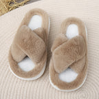 Pair of fluffy slippers on a textured surface