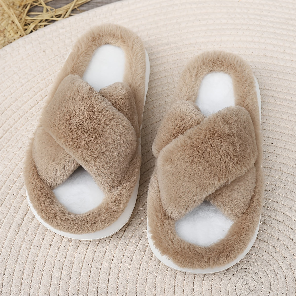 Pair of fluffy slippers on a textured surface