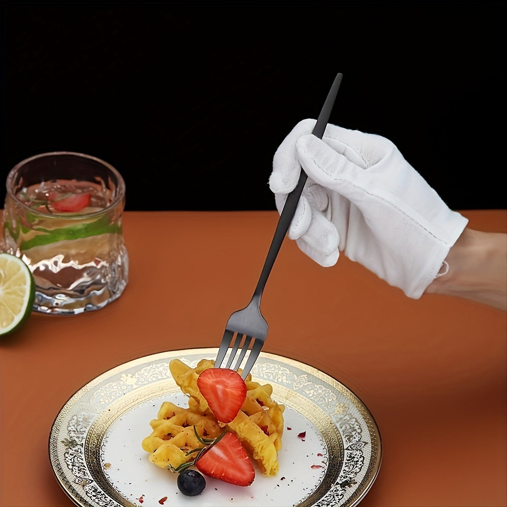 Hand in a white glove holding a fork over a plate of waffles with strawberries and a glass of water on a brown surface.